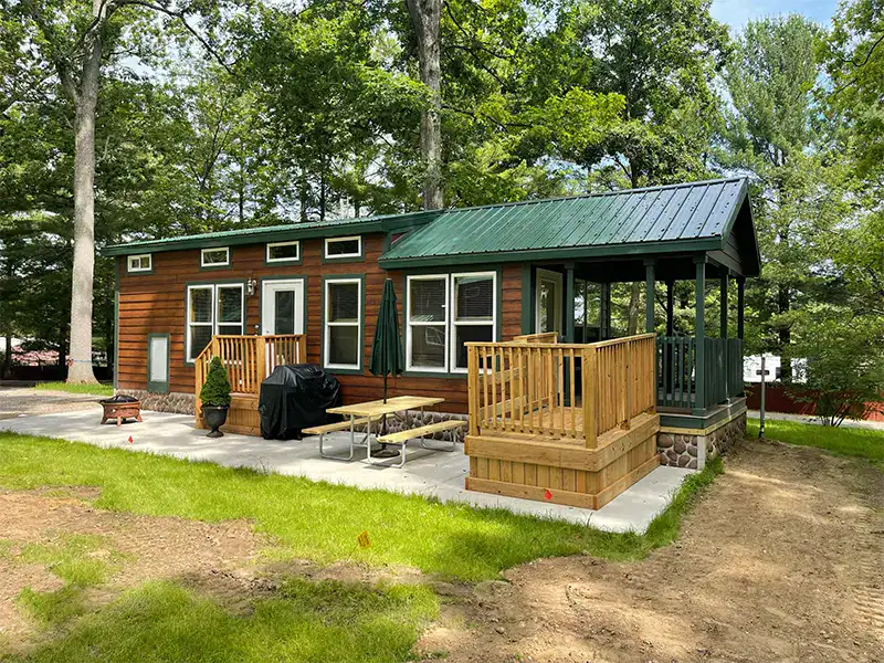 Outdoor recreation and family fun at Waldenwoods Resort. Enjoy a cozy cabin with a deck, picnic area, and scenic woodlands.