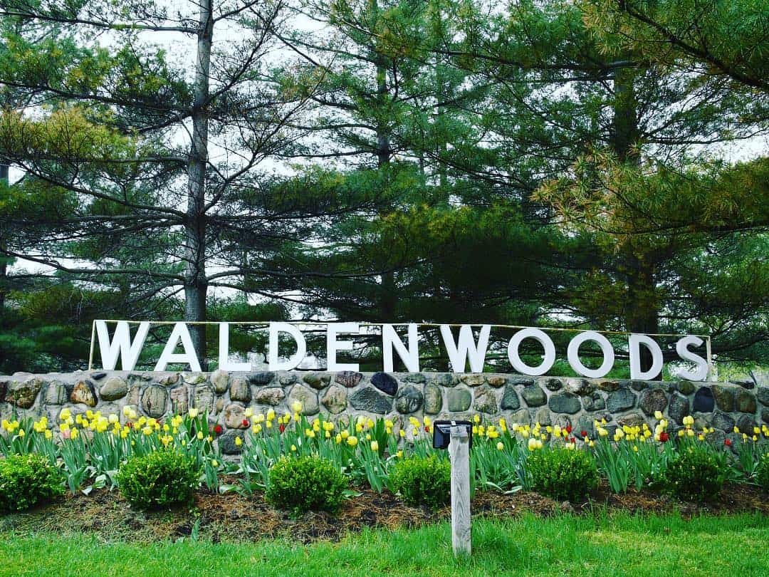 Waldenwoods Sign Beautiful outdoor sign at Waldenwoods Family Recreation Resort with lush greenery and colorful tulips.