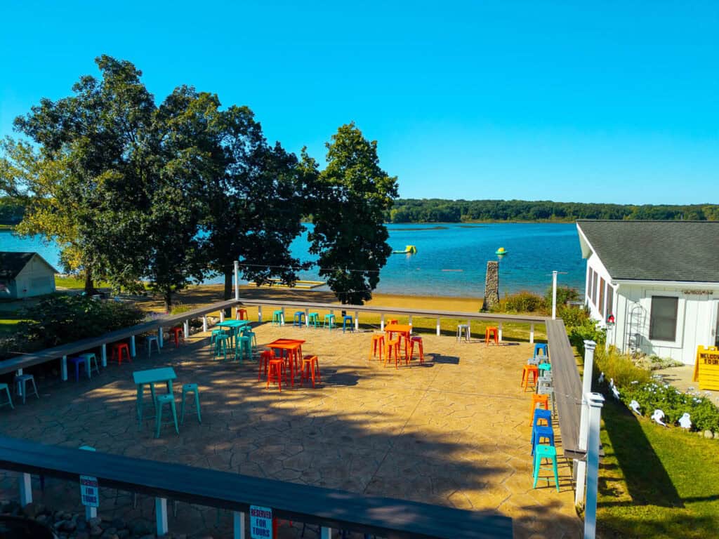 Spacious outdoor patio with colorful seating overlooking the lake and scenic views.